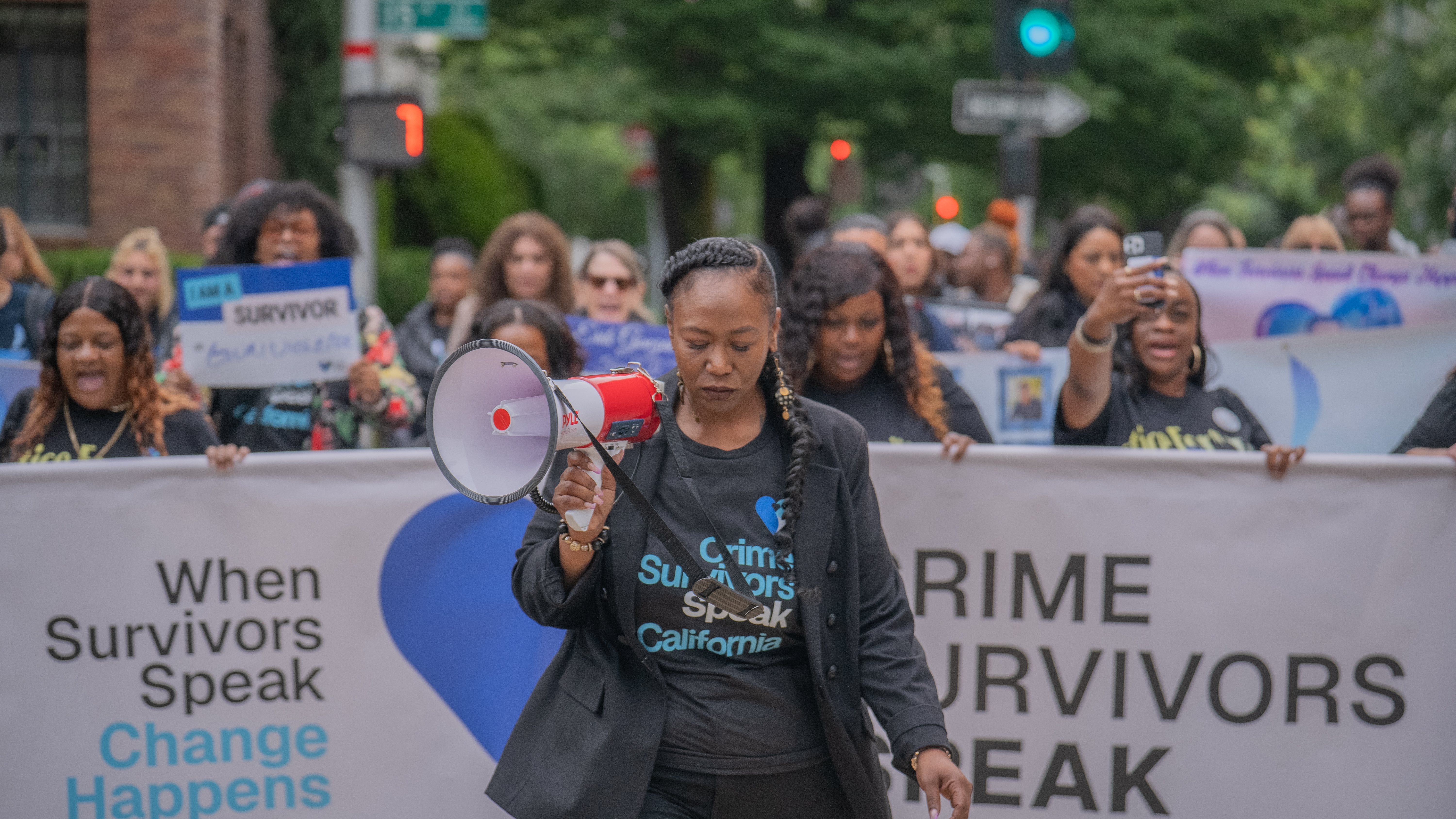 Tinisch Hollins leading a Crime Survivors Speak march with a megaphone